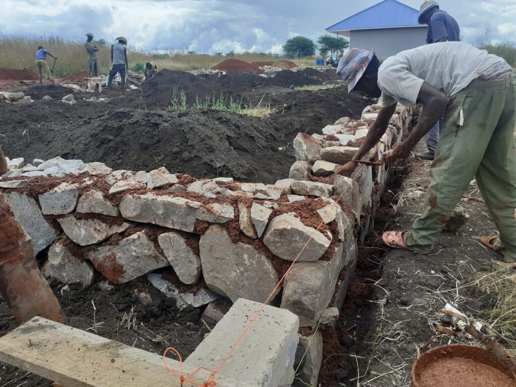 Worker building a stone wall.