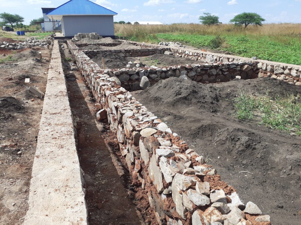 Construction site with stone foundation walls.