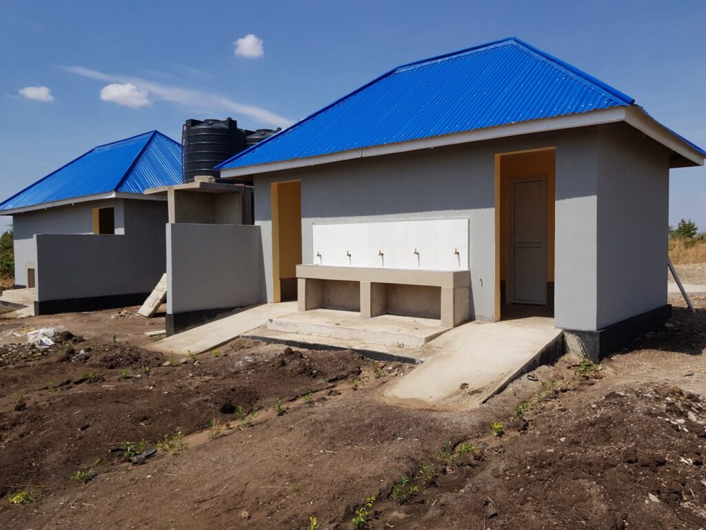 Buildings with blue roofs and water storage tanks.