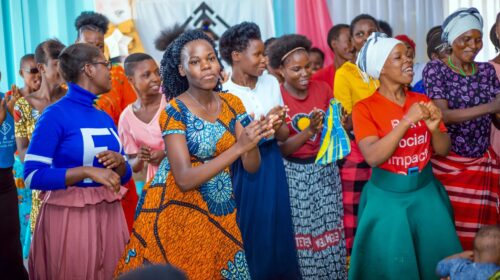 Group of women clapping and smiling.