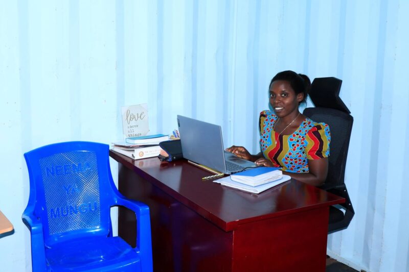 Woman working at a desk with a laptop.